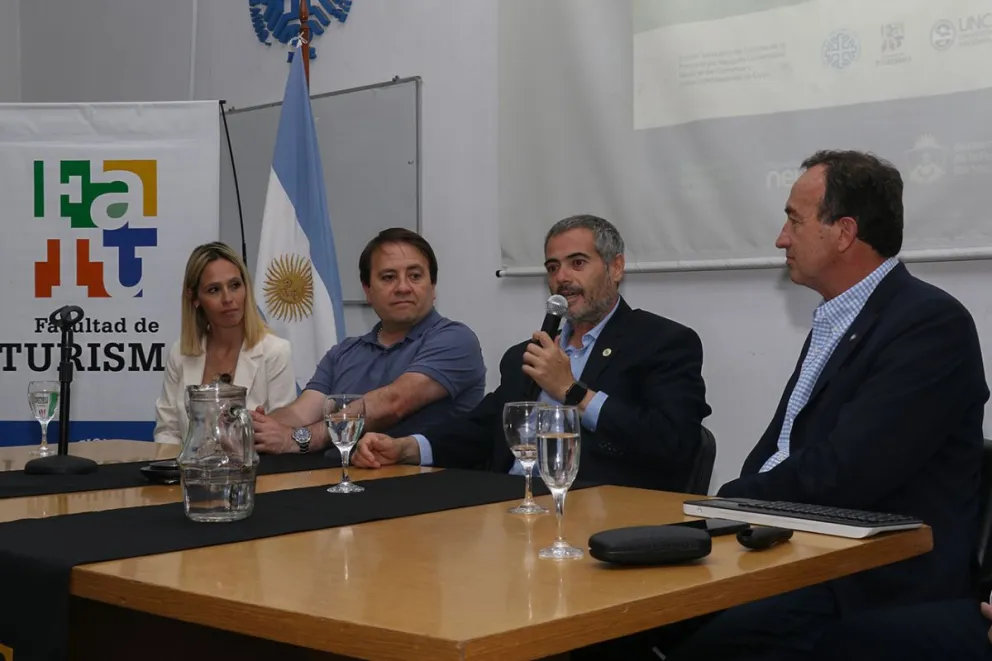 El ministro de Turismo de Neuquén, Gustavo Fernández Capiet, junto a especialistas y autoridades unviersitarias durante la charla.